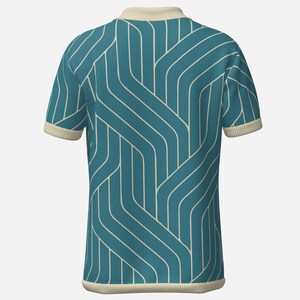 May include: Teal polo shirt with a cream-colored collar and sleeve cuffs. The shirt features a repeating white geometric pattern. The fabric has a ribbed texture. The shirt is a short-sleeved top.