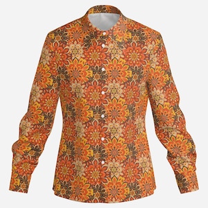 May include: A long-sleeved button-up shirt with a colorful, intricate pattern of orange, yellow, and brown. The pattern features a repeating design of stylized flowers.