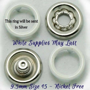 May include: Four silver-toned metal snap fasteners, two with white plastic rings, and two with a silver-toned metal base. The text "9.5mm Size 15 - Nickel Free" is printed below the fasteners. The text "This ring will be sent in Silver" is printed above the fasteners. The text "While Supplies May Last" is printed in the center of the image.