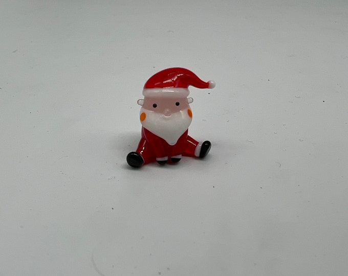 Miniature Santa sitting legs open