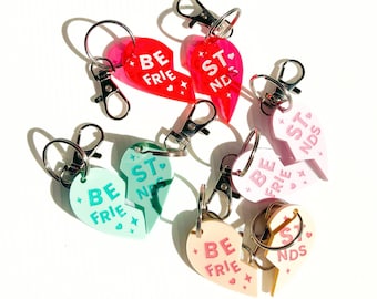 May include: Set of six heart-shaped keychains with the text "Best Friends" split between two halves. The keychains are in various colors, including pink, green, and light blue.