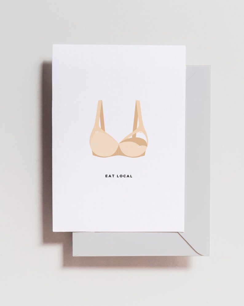 May include: A white card with a beige bra illustration and the text "EAT LOCAL" printed in black.