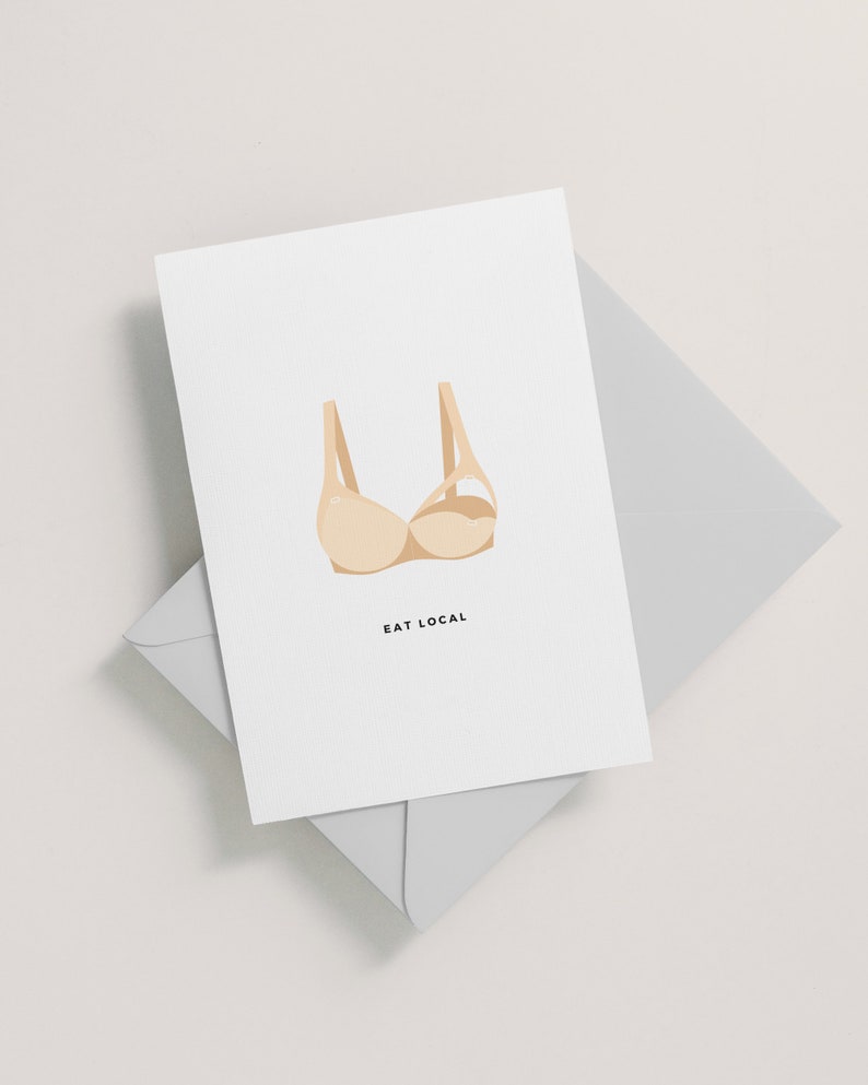 May include: A white card with a beige bra illustration and the text "EAT LOCAL" printed in black.