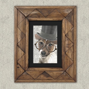 May include: A framed print of a dog wearing a black top hat and round glasses. The dog is looking directly at the viewer. The print is on a background of black and white text.