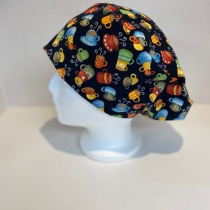 May include: Black scrub hat with a colorful coffee cup pattern.