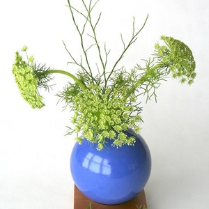 blue ceramic vase on wood base image 4