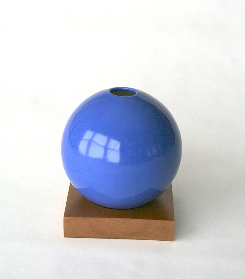 blue ceramic vase on wood base image 1