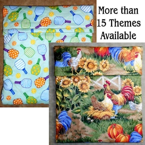 May include: Two quilted fabric items. One features a light green background with pickleball paddles and balls in various colors. The other depicts a farm scene with roosters, sunflowers, and pumpkins. Text reads "More than 15 Themes Available."