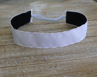 May include: White headband with black elastic and black fabric on the inside.
