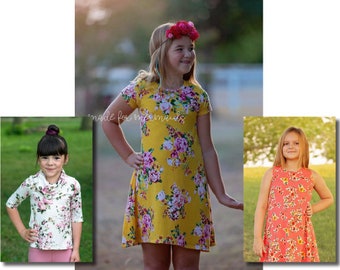 Peut inclure: Trois filles portant différentes versions du modèle "mya", un haut, une tunique et une robe. Le motif présente un imprimé floral en jaune, rose et blanc. Le texte "made for mermaids" est visible sur l'image.