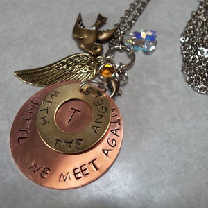 May include: A silver chain necklace with a copper pendant that reads "Until We Meet Again" with a smaller brass circle pendant that reads "The Angels" and a small bird charm.