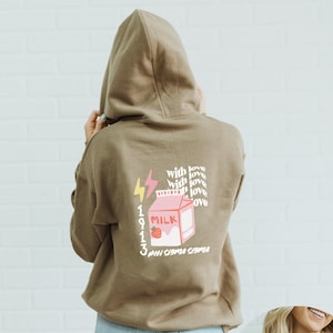 May include: A brown hooded sweatshirt with a pink milk carton graphic and the text "1913 PHI SIGMA SIGMA" and "with love" repeated four times.