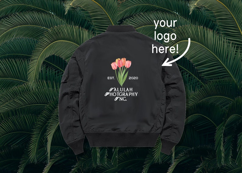 May include: Black bomber jacket with a white logo that says "ALULAH PHOTOGRAPHY NC" and "EST. 2020". The logo is surrounded by a floral design with pink and orange tulips.