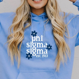 May include: A light blue hoodie with a white graphic that says "phi sigma sigma est. 1913" with blue flower accents.