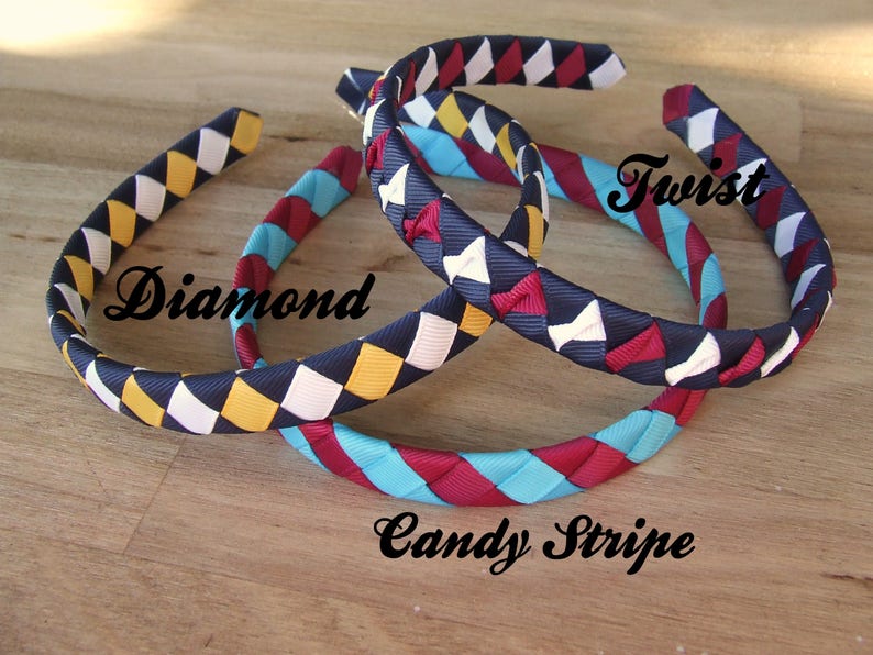 May include: Three colorful headbands made of woven ribbon. The headbands are in a diamond pattern, a candy stripe pattern, and a twist pattern. The headbands are navy blue, white, yellow, red, and turquoise.