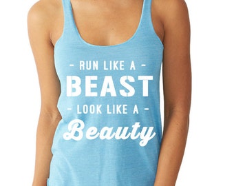 May include: Light blue racerback tank top with the text "Run Like a Beast - Look Like a Beauty" in white block letters. The tank top has a scoop neck and is made of a soft, lightweight material.