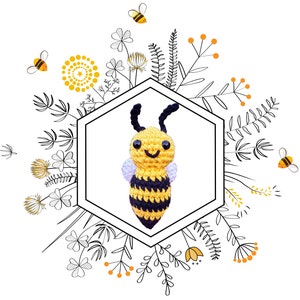 May include: A crocheted bee toy with black and yellow stripes, white wings, and a smiling face. The bee is surrounded by black and white floral designs.