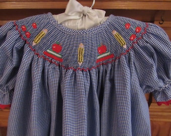 Back to school smocked bishop dress embroidere with crayons, books, pencils and apples.