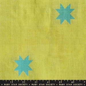 May include: Close-up of a yellow fabric with a textured appearance. Two teal-colored starburst shapes are evenly spaced across the surface. The bottom of the image contains text that reads "RUBY STAR SOCIETY".