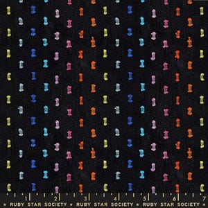 May include: Black fabric with a repeating pattern of colorful, textured, vertical shapes in yellow, orange, pink, blue, and green. The fabric has a soft, velvety texture. The text "RUBY STAR SOCIETY" is at the bottom.