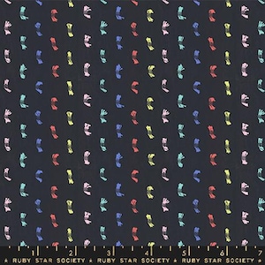 May include: Dark navy fabric with a repeating pattern of colorful, abstract shapes in red, yellow, blue, pink, and teal. The fabric has a subtle texture and is suitable for various sewing projects. The text "RUBY STAR SOCIETY" is printed at the bottom.