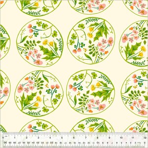 May include: A repeating pattern of floral designs on a cream background. Each circular design features pink and yellow flowers, green leaves, and stems, outlined in green. The pattern includes clovers and dandelions. The image includes a ruler with inch measurements.