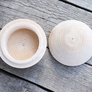 May include: Two wooden boxes, one with the lid open and the other with the lid closed. The boxes are made of light wood and have a smooth finish.