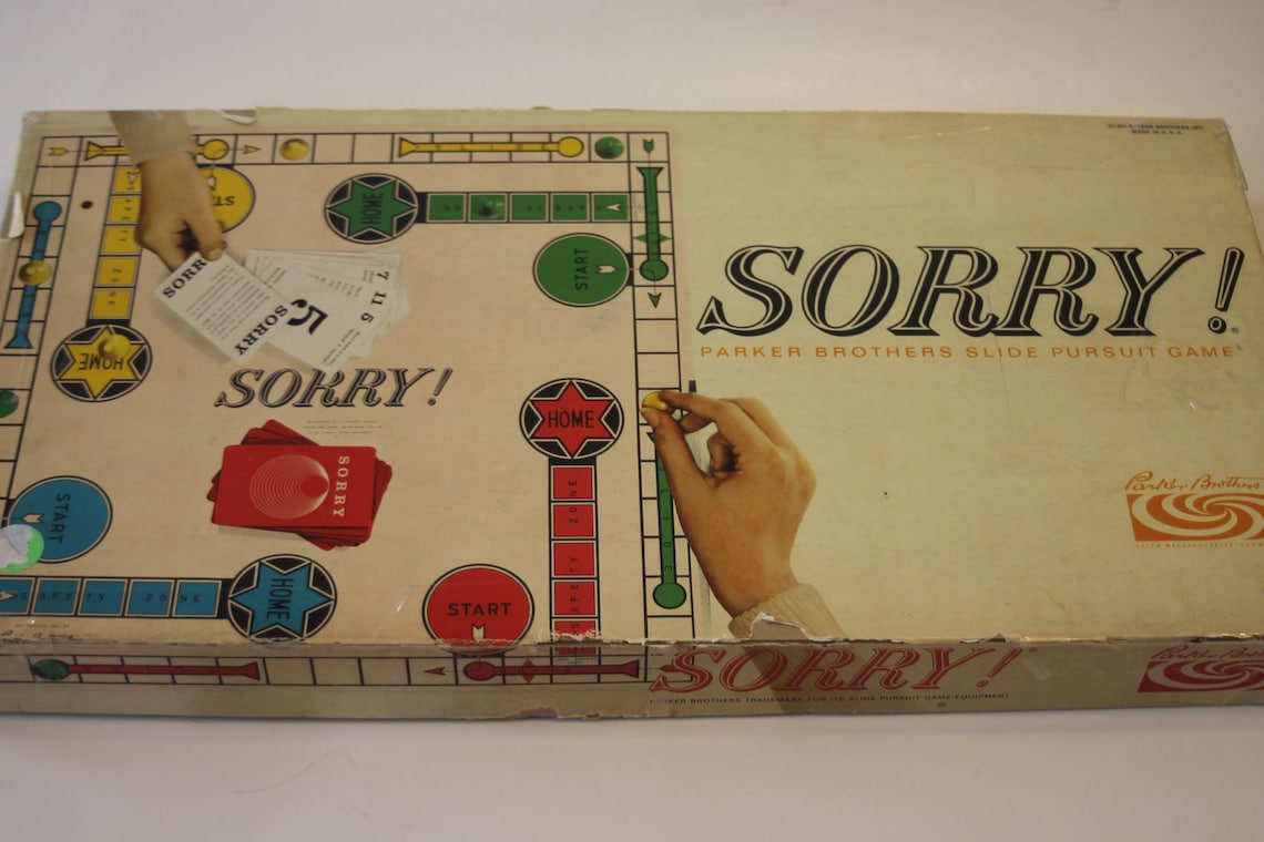 May include: Vintage Sorry! board game box.  The box is beige with green, blue, and red accents. The title 'SORRY!' is prominently displayed in bold, black lettering.  The game's subtitle, 'Parker Brothers Slide Pursuit Game,' is also visible. The box shows the game board's layout with its paths, home spaces, and start points.  The game's cards are visible, along with game pieces. The Parker Brothers logo is present on the box.