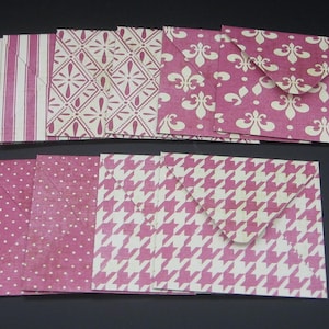 May include: A collection of ten rectangular paper envelopes featuring various patterns in shades of magenta and white. The designs include vertical stripes, diamond lattice, fleur-de-lis, polka dots, and houndstooth prints on each individual envelope.