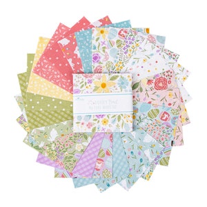May include: A collection of 12 fabric squares featuring a variety of Easter-themed prints. The prints include bunnies, eggs, flowers, and other spring motifs. The fabric squares are arranged in a fan shape and are labeled "Bunny Trail by Lori Holt".
