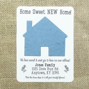 May include: A white card with a blue paper house shape that can be planted to grow flowers. The card says "Home Sweet NEW Home!" and includes the text "We have moved & want you to have our new address! Jones Family 1025 Dove Run Rd Anytown, KY 12345 Plant this house shape & it will grow beautiful flowers!"