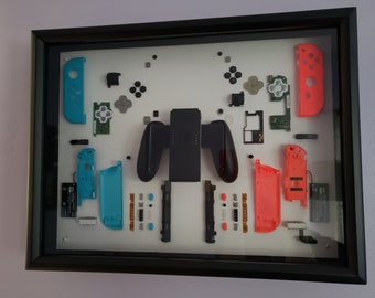 Mandos Joy-Con de Nintendo Switch: vista interior, caja con marco negro (Joy-Con azul y rojo originales de Nintendo Switch)