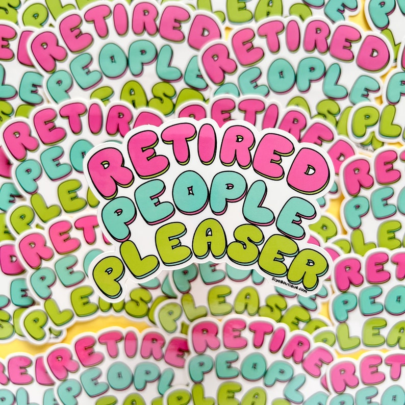 May include: A close-up of a stack of stickers that say "Retired People Pleaser" in pink, green, and blue bubble letters. The stickers are on a yellow background.