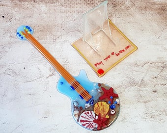 A collector&#39;s item, a glass guitar on a stand inspired by the sea