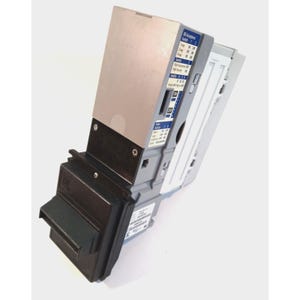 May include: A grey and black electronic bill validator featuring a front-facing slot for currency insertion. The side panel displays a printed chart labeled Bill Acceptance Switch with settings for 1 way, 2 way, and 4 way, along with various configuration switches.