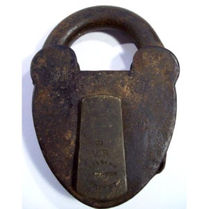 May include: A vintage cast iron padlock with a heart-shaped design. The padlock has a V.R. stamp and the words "PATENTED" and "NOV 27 1877".