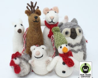 May include: A collection of handmade felt animal ornaments, including a reindeer, mouse, koala, snowman, polar bear, chicken, and dog. Each ornament has a string for hanging and is made with various colors of felt. The ornaments are Fair Trade Certified.