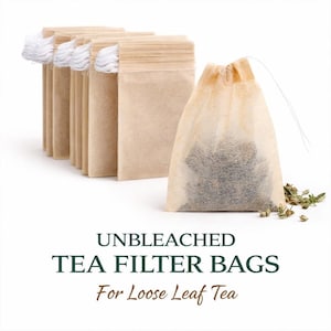 May include: Unbleached tea filter bags for loose leaf tea. The image shows a stack of empty beige paper tea bags with white string and a filled tea bag with loose tea inside. The text on the image reads "Unbleached Tea Filter Bags For Loose Leaf Tea."