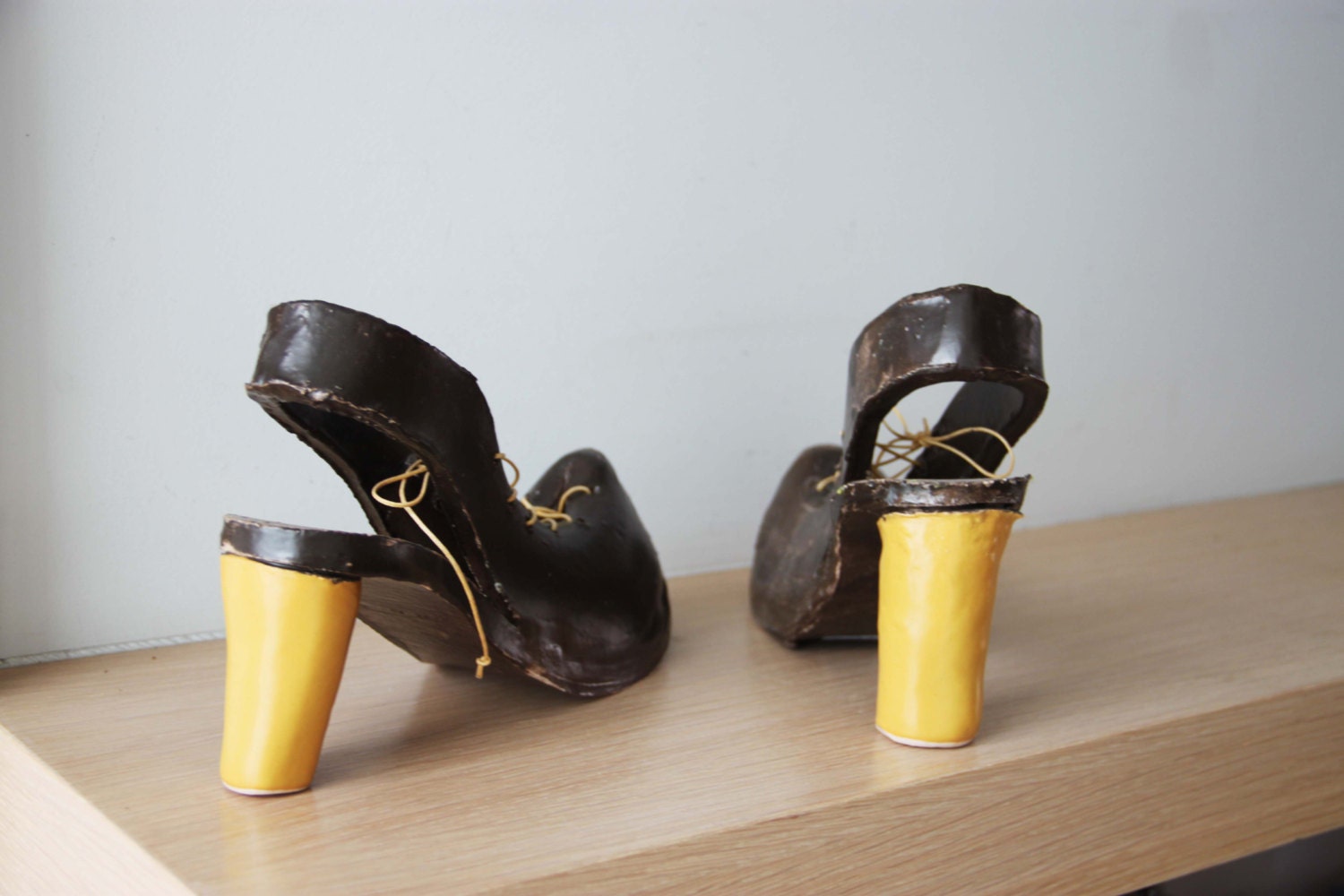 Ceramic shoes sculpture, high heel shoes in brown and yellow, life size
