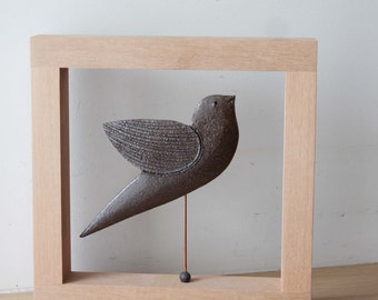 Brown bird sculpture, ceramic bird on metal stem inside wooden frame, minimalist ceramic bird wall hanging