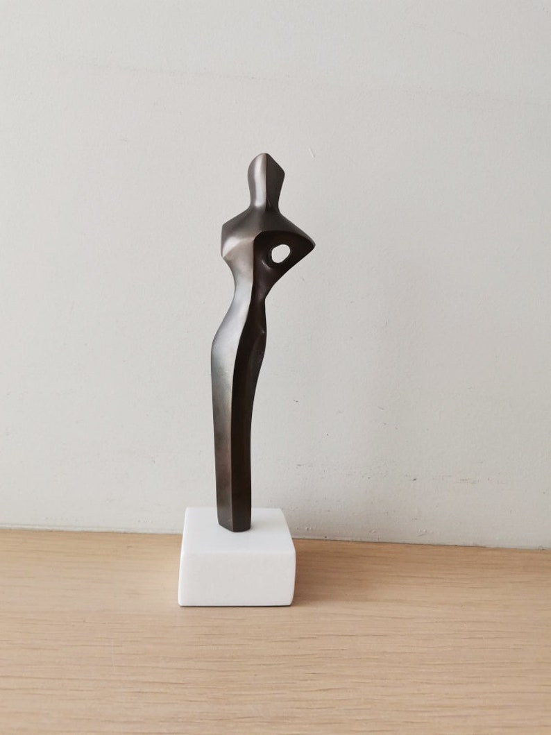 Abstract figure sculpture, solid brass, brute minimalist aesthetic, oxidised brass woman figure on marble image 2