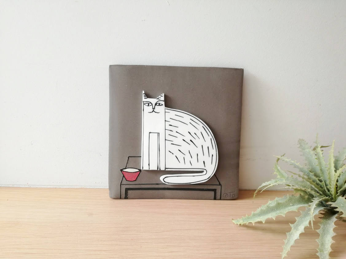 Sitting cat wall hanging, porcelain cat in grey background