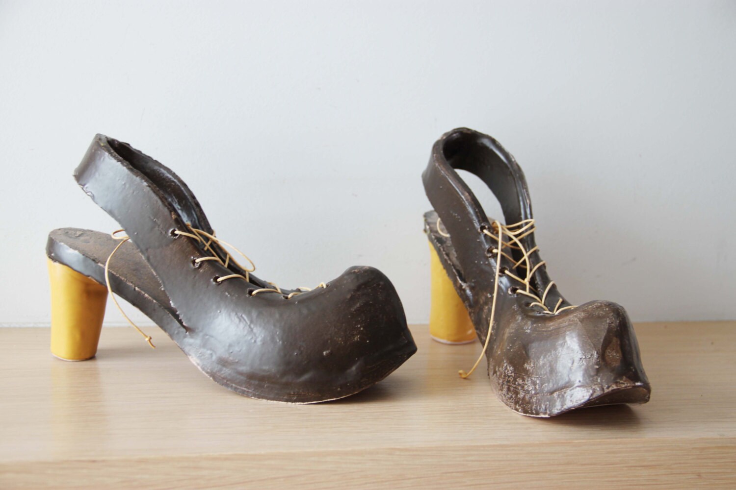 Ceramic shoes sculpture, high heel shoes in brown and yellow, life size