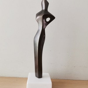 Abstract figure sculpture, solid brass, brute minimalist aesthetic, oxidised brass woman figure on marble image 1