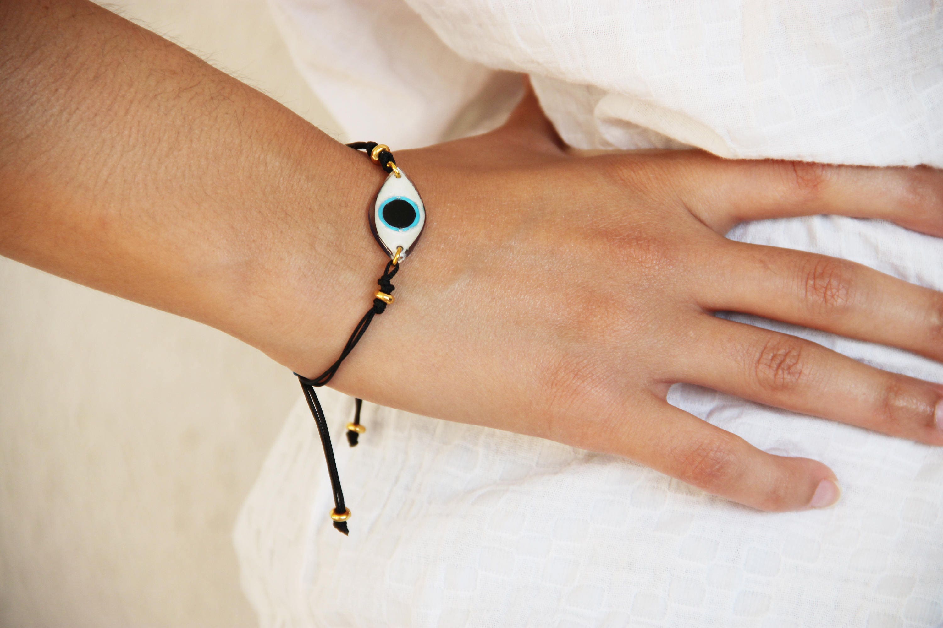 Blue eye bracelet, oval blue eye of plexi glass and resin on black cord
