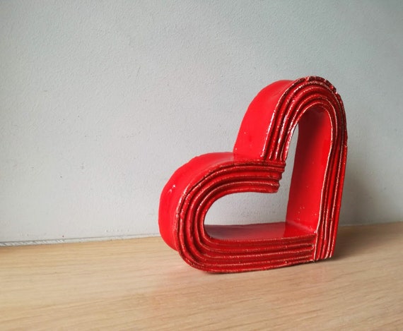 Red heart sculpture, bright red, ceramic heart outline sculpture, stands on the side, modern heart  art object
