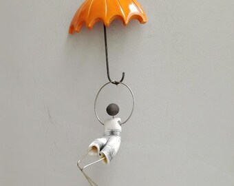 Figure with orange umbrella , wall umbrella miniature with abstract figurine, orange umbrella and figurine art object