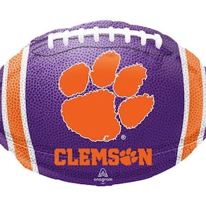 May include: Purple and orange football-shaped balloon with the Clemson Tigers logo and the word "CLEMSON" printed on it.