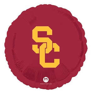 May include: Red and gold foil balloon with the letters "SC" in a stylized font.