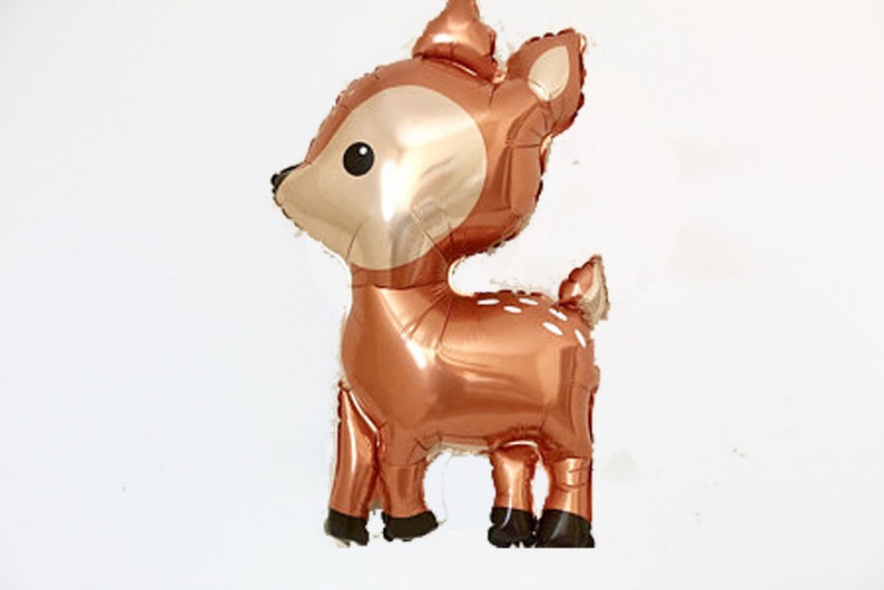 May include: A copper-colored foil balloon shaped like a deer with white spots. The deer has a brown nose and black eyes.